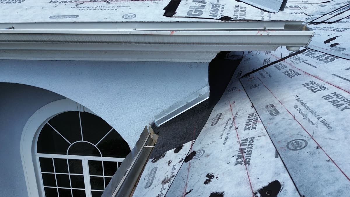 A short strip of new flashing metal applied at a wall transition without being properly integrated into the surrounding roofing system